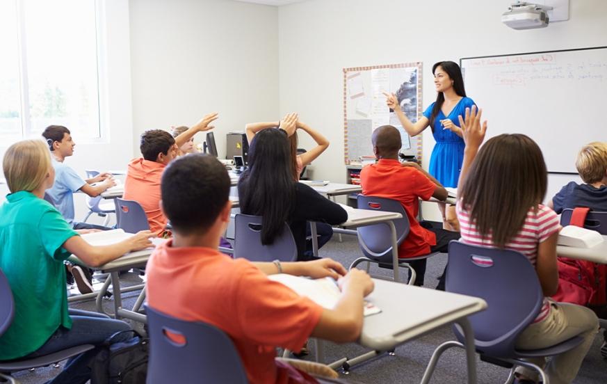 Para to teacher student teaching in front of classroom